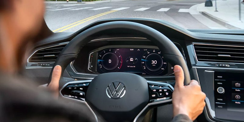Driver’s view of Volkswagen Tiguan digital cockpit and steering wheel display.