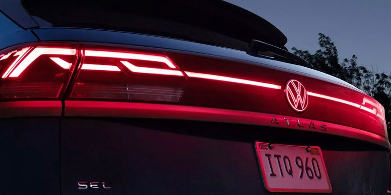 2026 Volkswagen Atlas Cross Sport rear LED taillights illuminated at night