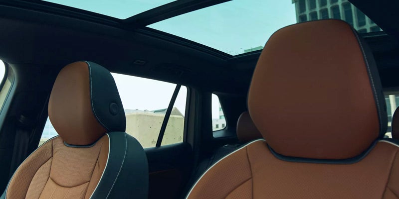 Interior of the 2026 Volkswagen Tiguan featuring brown leather seats and panoramic sunroof.