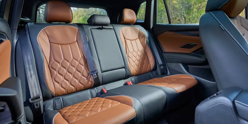 Rear passenger seats of the 2026 Volkswagen Tiguan with brown quilted leather upholstery.